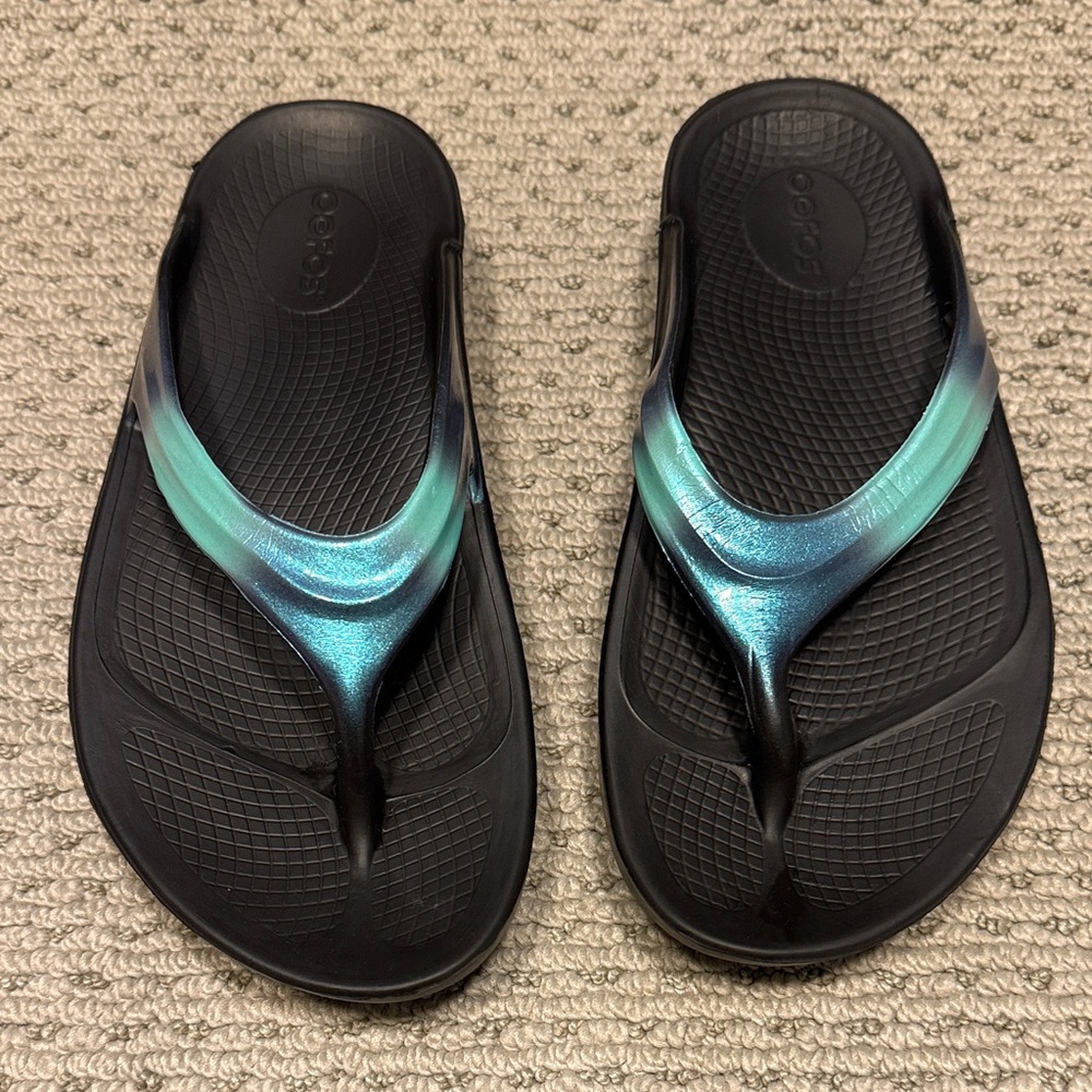 OOFOS Black Flip Flops with Teal Iridescent Straps